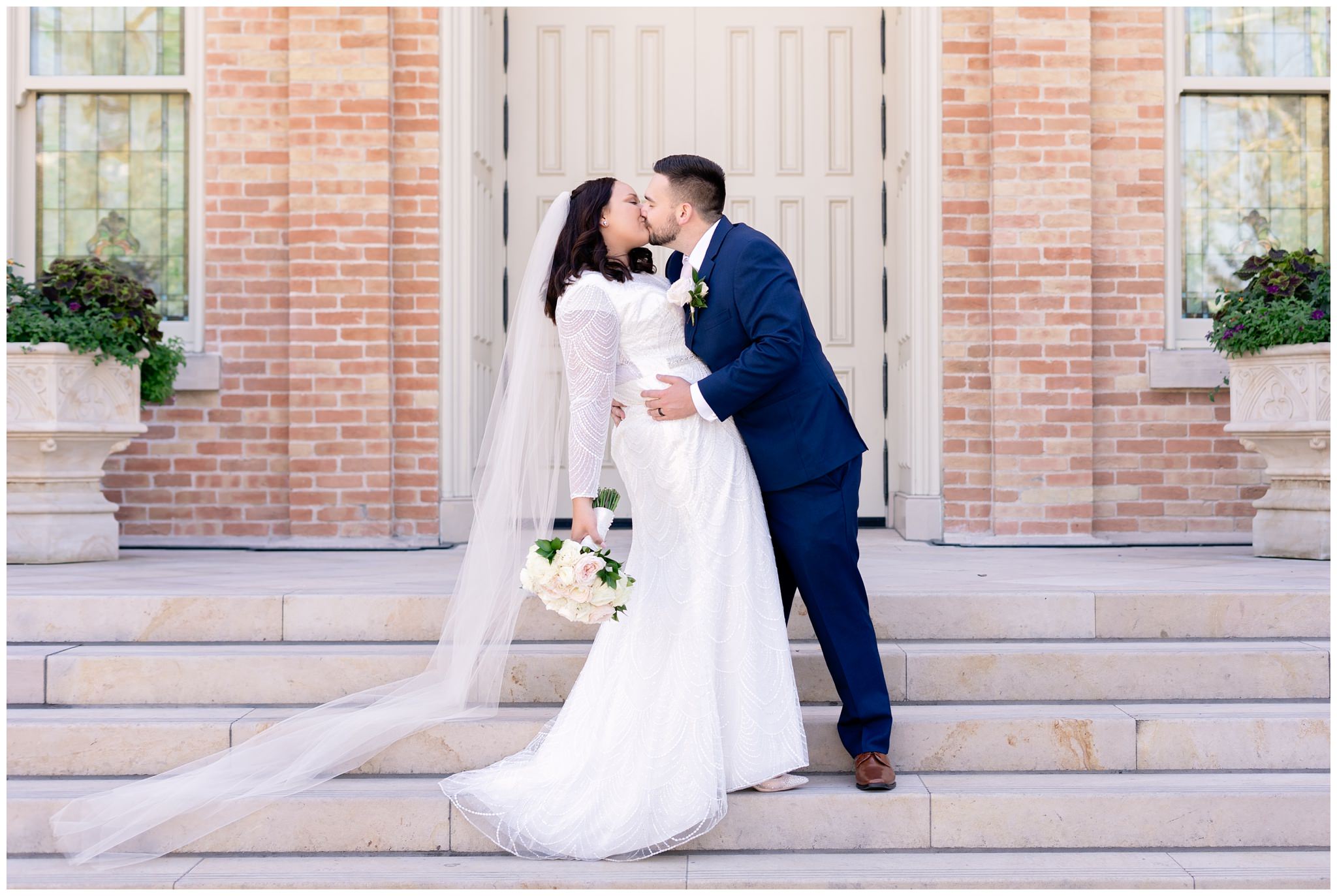 Bride and groom kissing on Temple steps