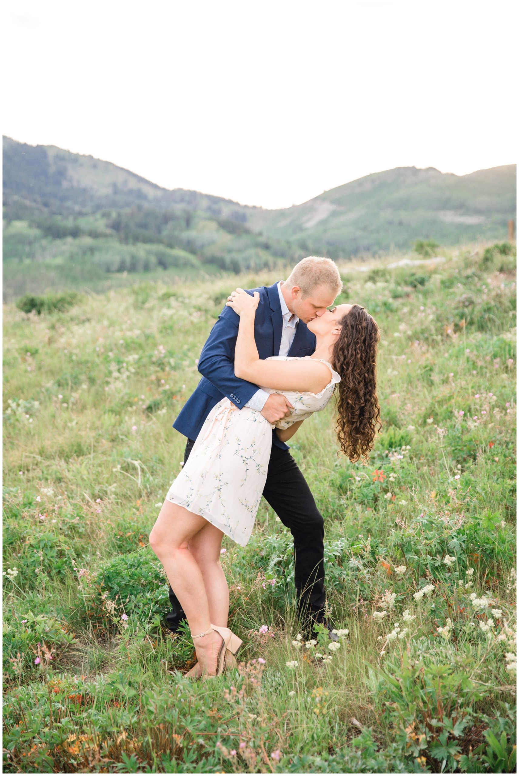 Couple Kissing in a field of flowers for their Engagements in Park City Utah