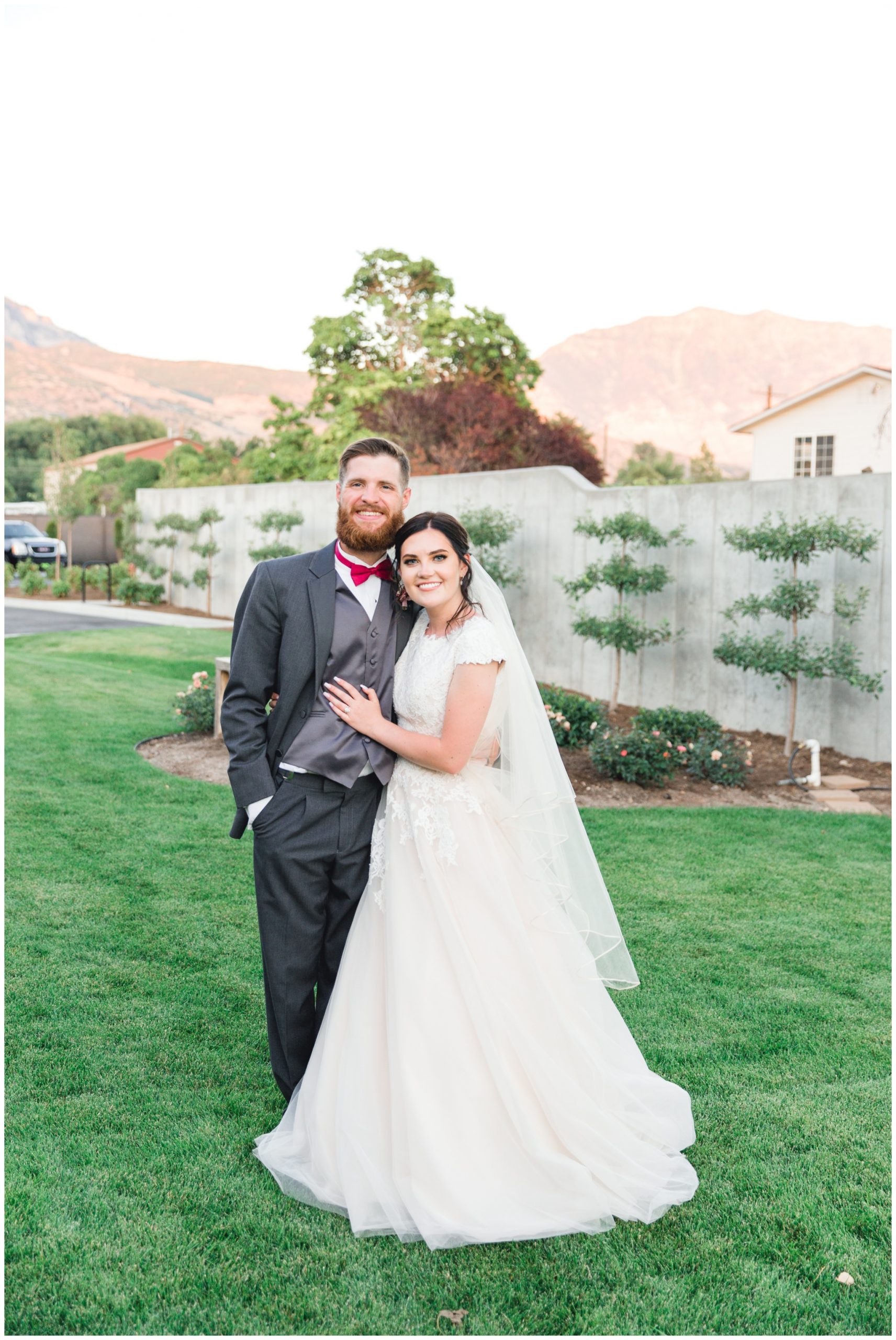 Bride and groom smiling at camera at their reception in Lindon, Utah
