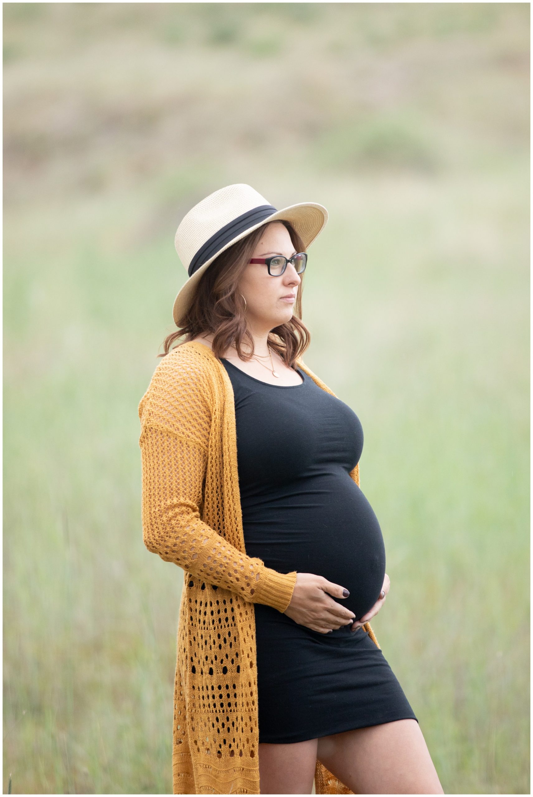 pregnant woman wearing a black maternity dress in Idaho.