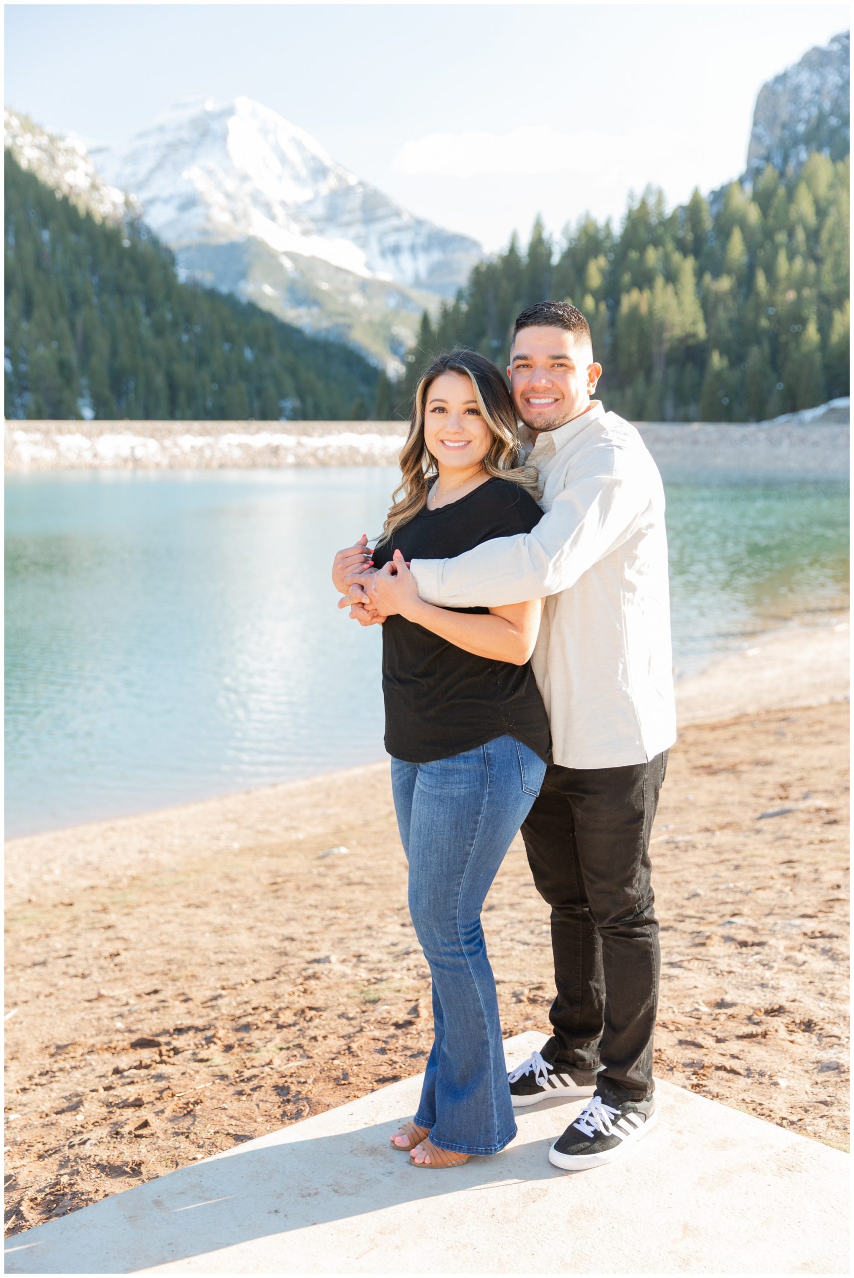 Couple posing by a lake in the mountains of Utah