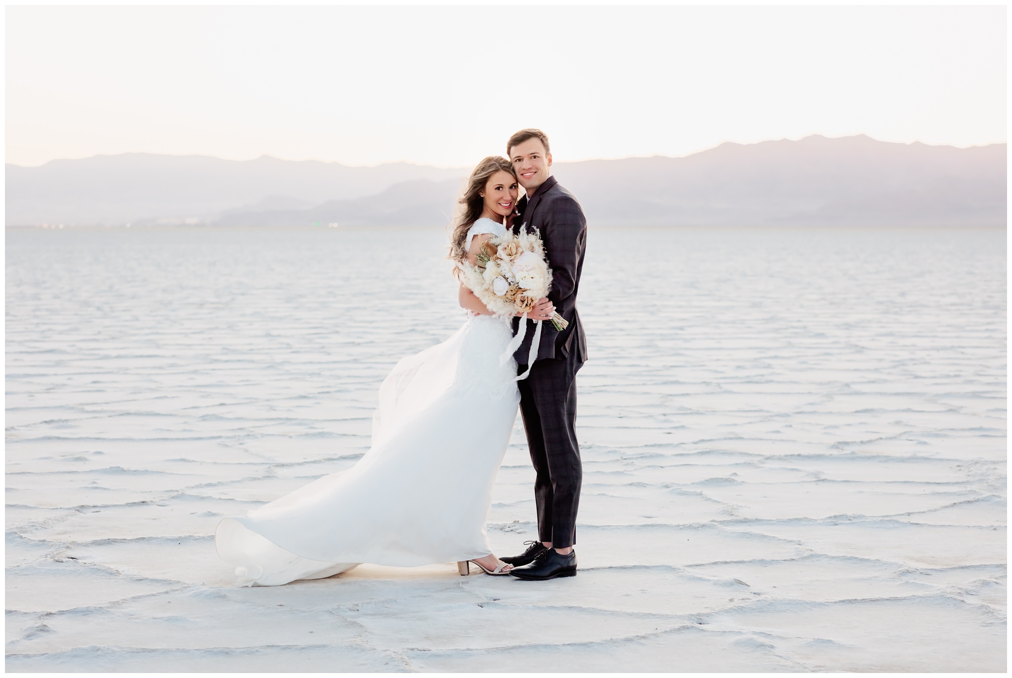 Bride and groom smiling for a portrait at the Salt Flats in Utah
