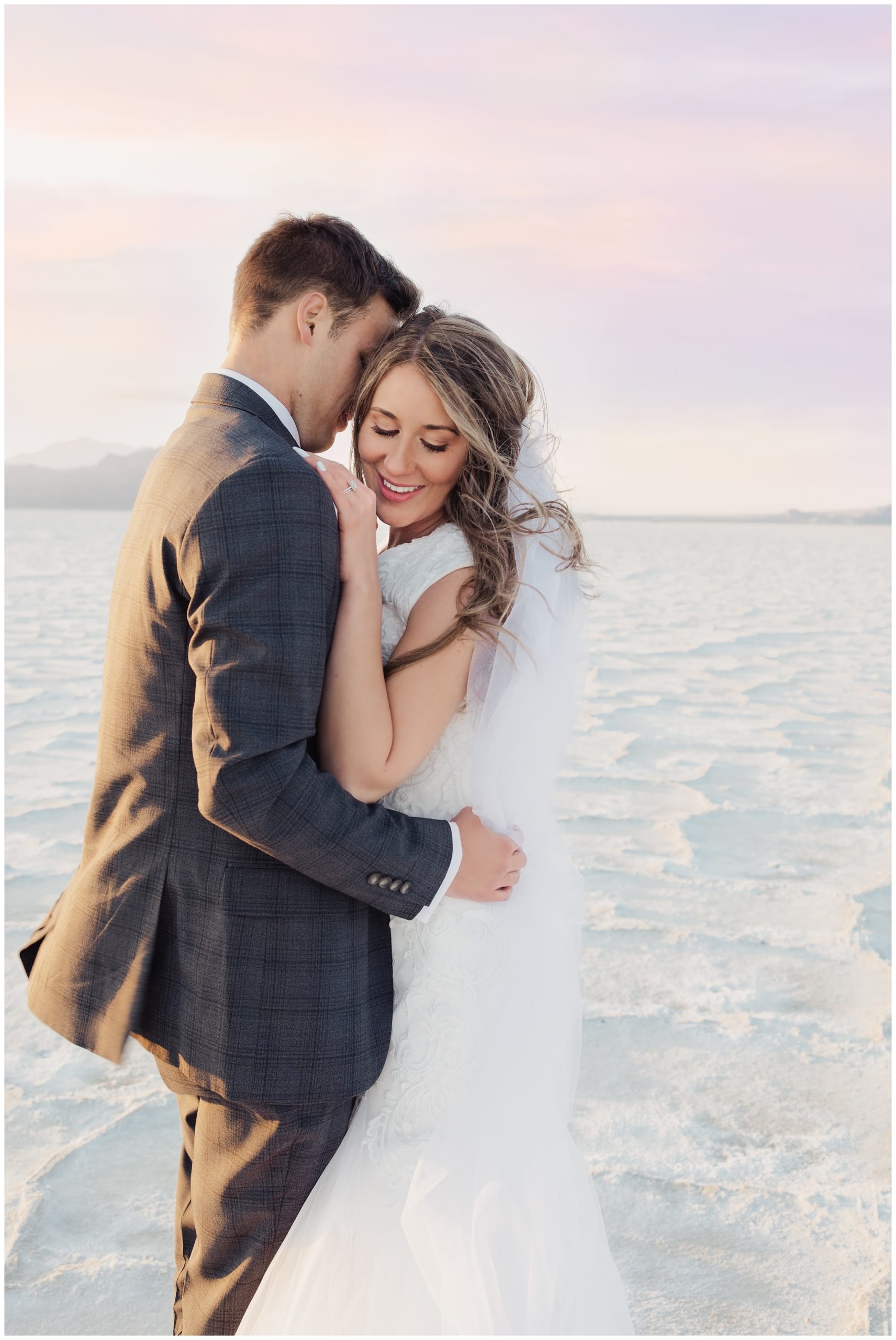 Bride and groom embracing at the Utah Bonneville Salt Flats in the summer