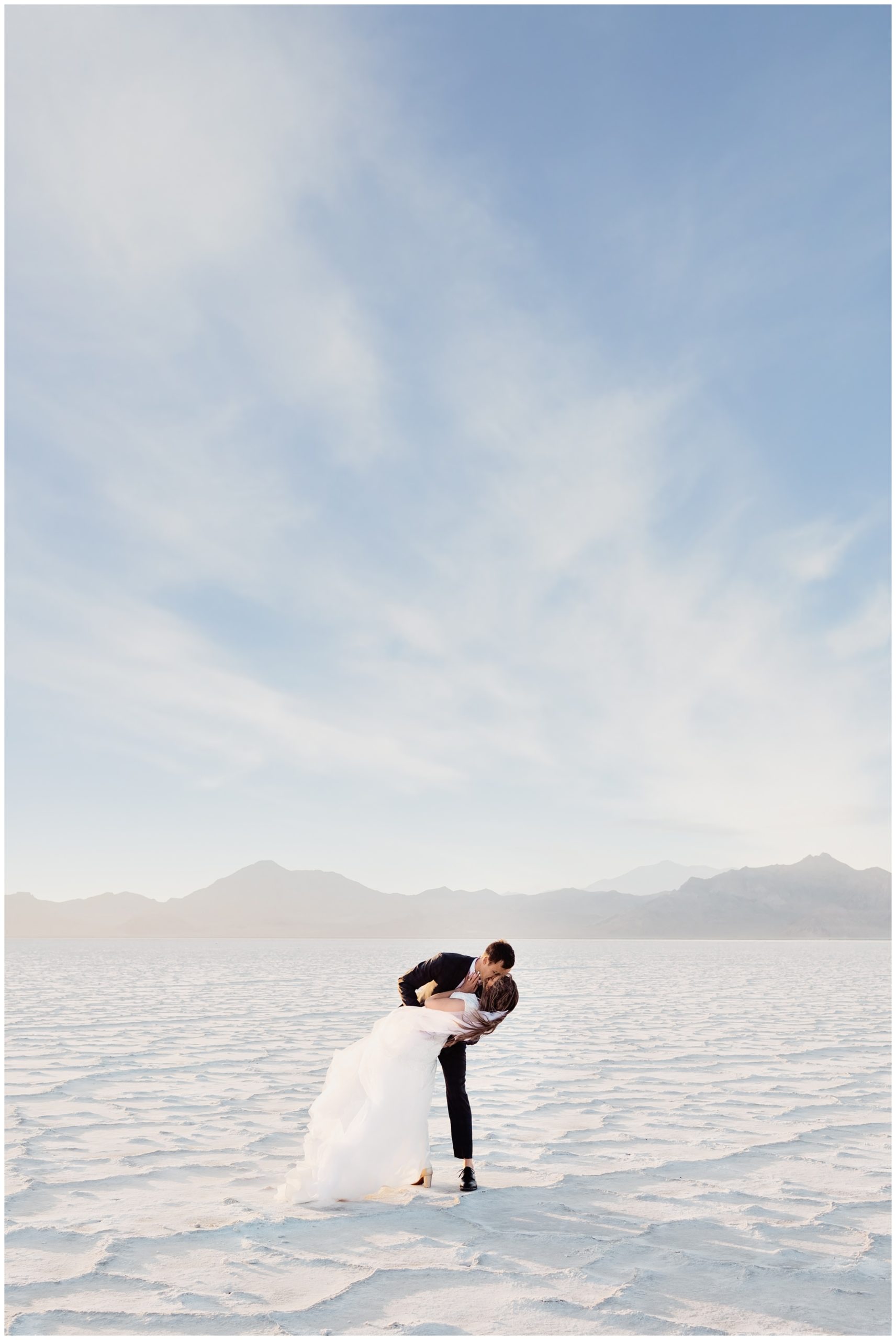 Groom dipping the bride for a quick kiss near Salt Lake city Salt Flats