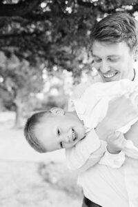 Father tickling son Lubbock Texas family pictures